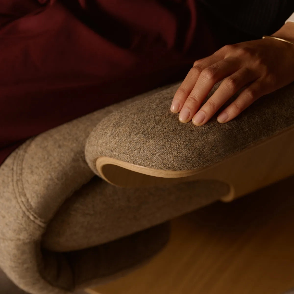 Rest your hand on the armrest of a Stressless Adam upholstered in Clover Funghi fabric, where the controls are located underneath